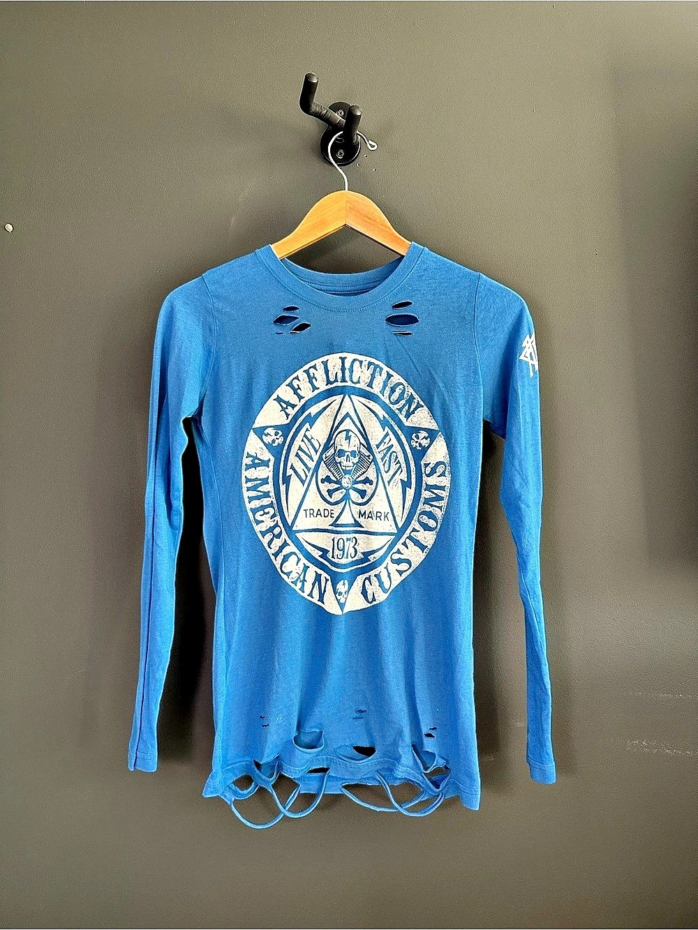 Affliction blue long sleeve shirt with white circular logo featuring skull and t